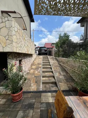 a car is driving down a wooden walkway at Apartman Omerovic - Panon Centar Tuzla in Tuzla