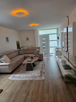 a living room with a couch and a table at Apartman Omerovic - Panon Centar Tuzla in Tuzla