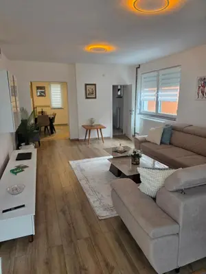 a living room with a couch and a table at Apartman Omerovic - Panon Centar Tuzla in Tuzla