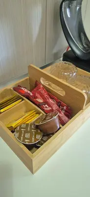 a wooden box filled with different types of chopsticks at Apartman Stanković in Teslić