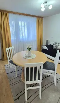 a living room with a table and chairs and a couch at Apartman Stanković in Teslić