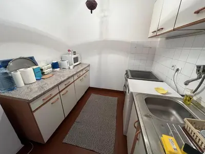 a small kitchen with a sink and a microwave at Apartman Lavanda in Živinice
