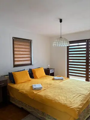 a bedroom with a large bed with two towels on it at Apartman Kahvica in Travnik