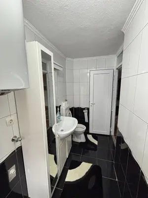 a bathroom with a white sink and a toilet at Apartman Kahvica in Travnik
