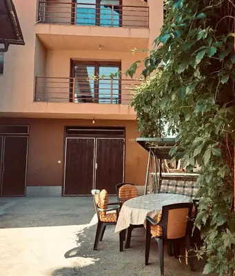 a table and chairs in front of a house at Apartman Kahvica in Travnik