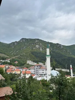 a city with a town with a mountain in the background at Apartman Kahvica in Travnik