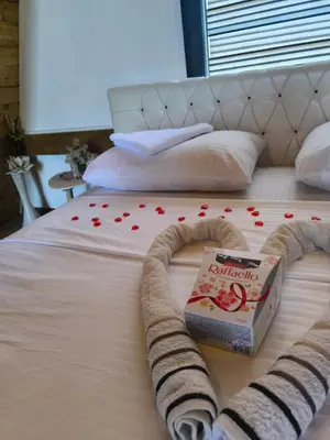 a bed with a book and red hearts on it at Atrijland Cazin in Cazin