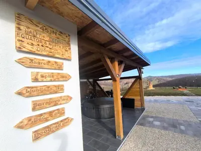 a house with wooden signs on the side of a building at Atrijland Cazin in Cazin