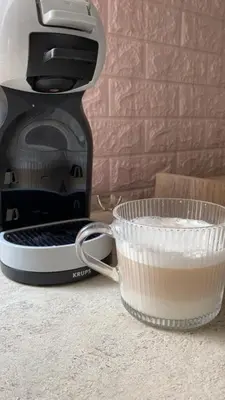 a cup of milk next to a coffee maker at Royal Luxury Apartment in Bihać