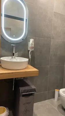a bathroom with a sink and a mirror at Royal Luxury Apartment in Bihać
