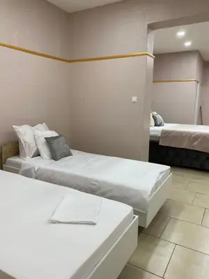 a hotel room with two beds and a mirror at Royal Luxury Apartment in Bihać