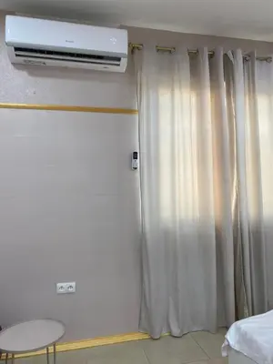 a room with a bed and a window with curtains at Royal Luxury Apartment in Bihać