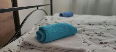 a blue towel sitting on top of a bed at Apartman Maja 46 in Doboj