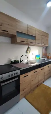 a kitchen with a sink and a stove at Apartman Maja 46 in Doboj
