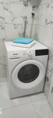 a washing machine with a towel on top of it at Apartman Maja 46 in Doboj