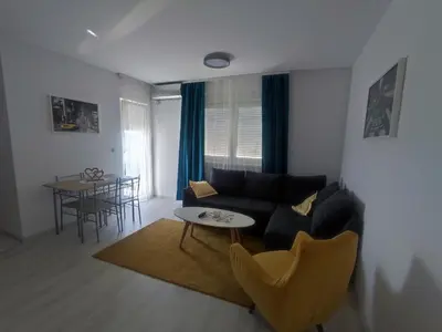 a living room with a couch and a table at Apartman Maja 46 in Doboj