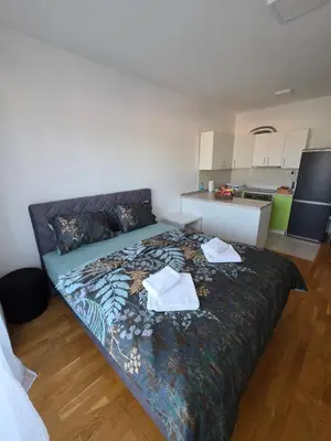 a bedroom with a bed with two towels on it at Dana'S in Doboj