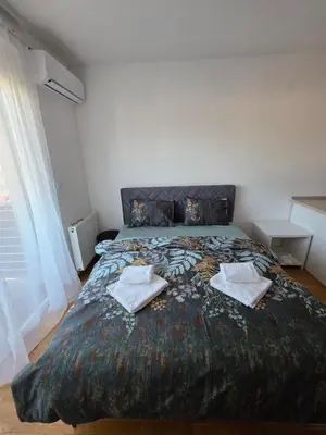 a bedroom with a large bed with two towels on it at Dana'S in Doboj