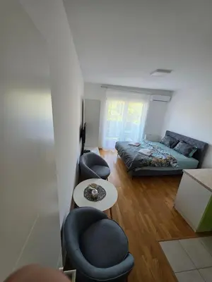 a living room with a bed and a couch at Dana'S in Doboj