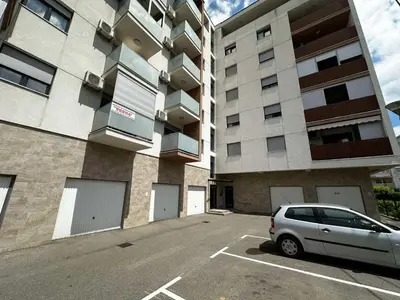 a car parked in a parking lot in front of a building at Dana'S in Doboj