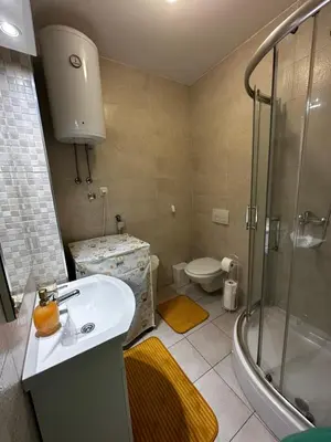 a bathroom with a sink and a shower and a toilet at Dana'S in Doboj