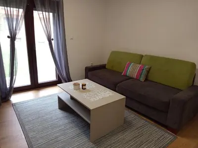 a living room with a couch and a coffee table at Apartmani Piralis in Bihać