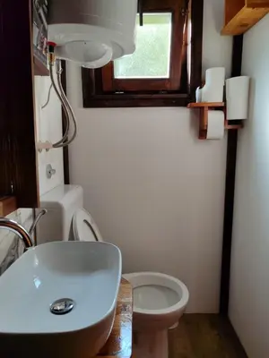 a bathroom with a toilet and a sink and a window at Plivski raj in Jezero
