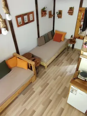 two beds in a room with wooden floors at Plivski raj in Jezero