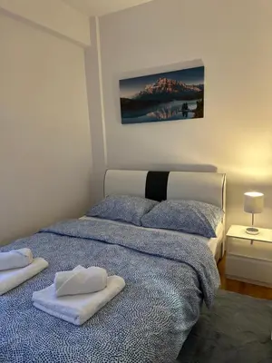 a bedroom with a bed with two towels on it at Apartman Radmanović in Banja Luka
