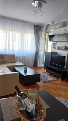 a living room with a bottle of wine on a table at Venecija Most in Banja Luka