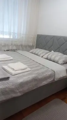 two beds in a room with white towels on them at Venecija Most in Banja Luka