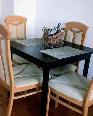 a black table with two chairs and a basket on top at Venecija Most in Banja Luka