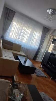 a living room with a couch and a television at Venecija Most in Banja Luka