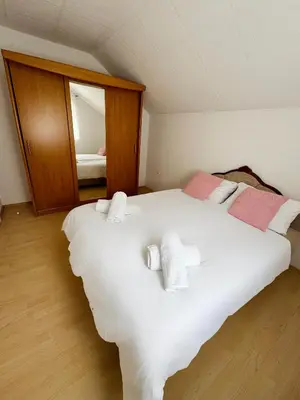 a large white bed in a room with a mirror at Una-Luxury-suite in Bihać