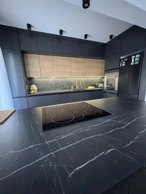 a kitchen with a black counter top and a sink at Una-Luxury-suite in Bihać
