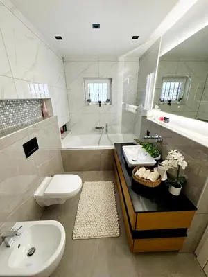 a bathroom with a sink and a toilet and a tub at Una-Luxury-suite in Bihać