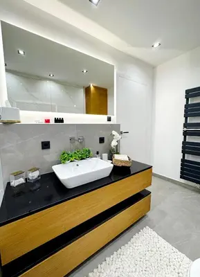 a bathroom with a sink and a large mirror at Una-Luxury-suite in Bihać