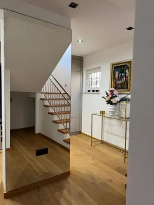 a mirror in the hallway of a house with a staircase at Una-Luxury-suite in Bihać