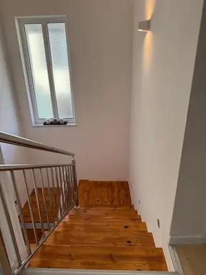 a stairwell with a wooden floor and a window at Una-Luxury-suite in Bihać