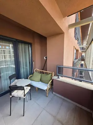 a balcony with a couch and a table and chairs at Apartman RS Palata in Banja Luka