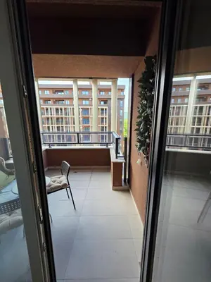 a hallway with a chair and windows in a building at Apartman RS Palata in Banja Luka
