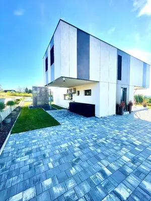 a large white building with a brick driveway at Villa Evora in Banja Luka