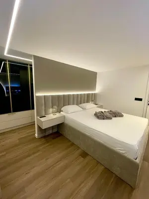 a bedroom with a large white bed and a window at Villa Evora in Banja Luka