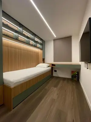 a small bedroom with a bed and a chalkboard at Villa Evora in Banja Luka