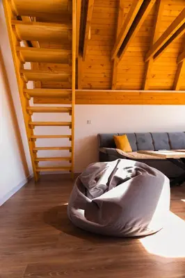 a bed sitting on the floor in a room with a couch at Villa Tajna in Brčko