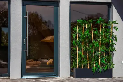 a door with two potted plants in front of it at Villa Tajna in Brčko