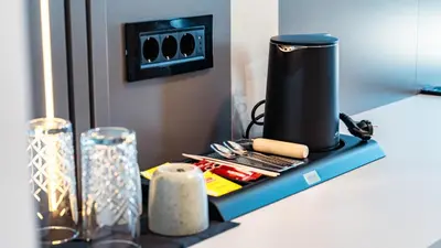 a counter with a coffee maker on a shelf at Hotel Branch in Doboj