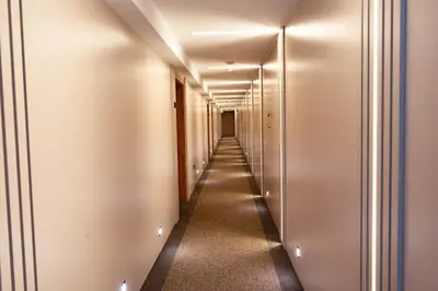 a corridor of elevators in a building with lights at Hotel Branch in Doboj