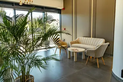 a waiting room with a chair and a table at Hotel Branch in Doboj