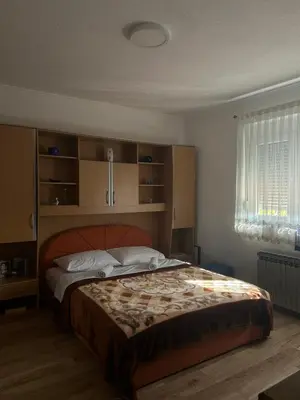 a bedroom with a large bed in a room at Apartman Iris in Bosanski Brod